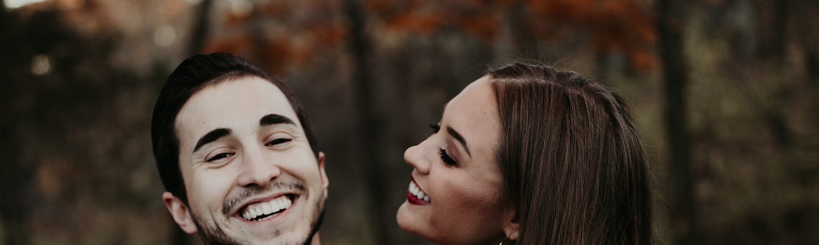 Man smiling, woman smiling with a hug. People magnets