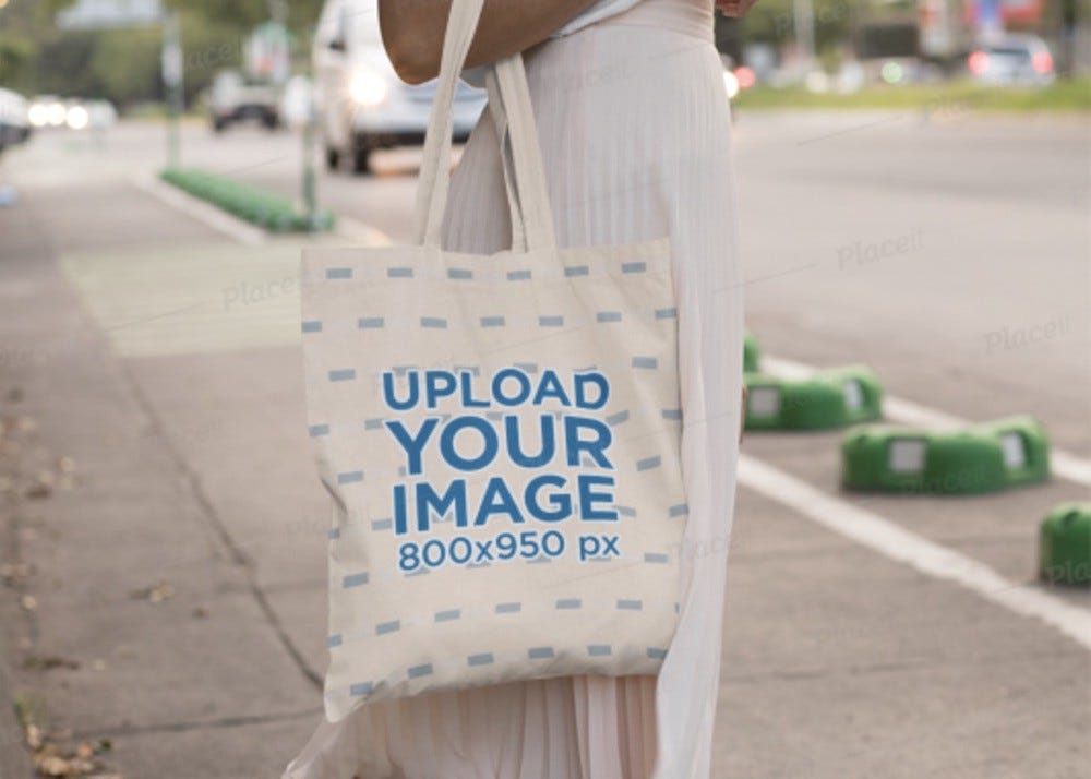woman with headphones posing with a canvas bag