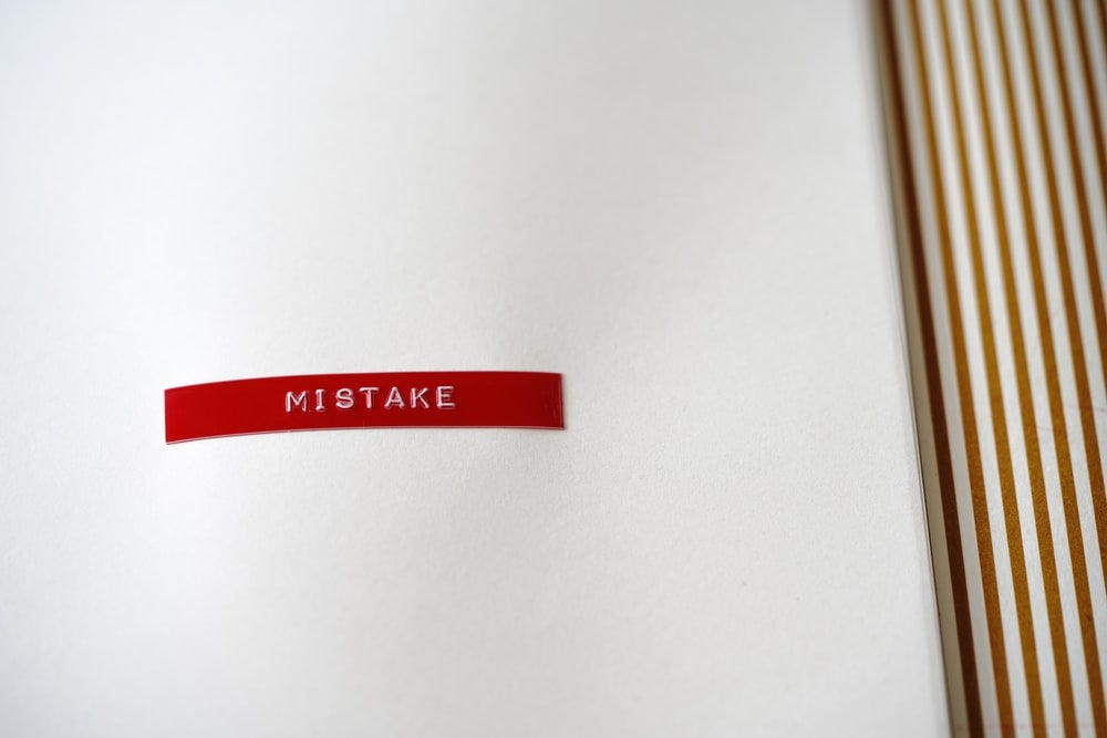 A white notebook page with a red “mistake” on it.
