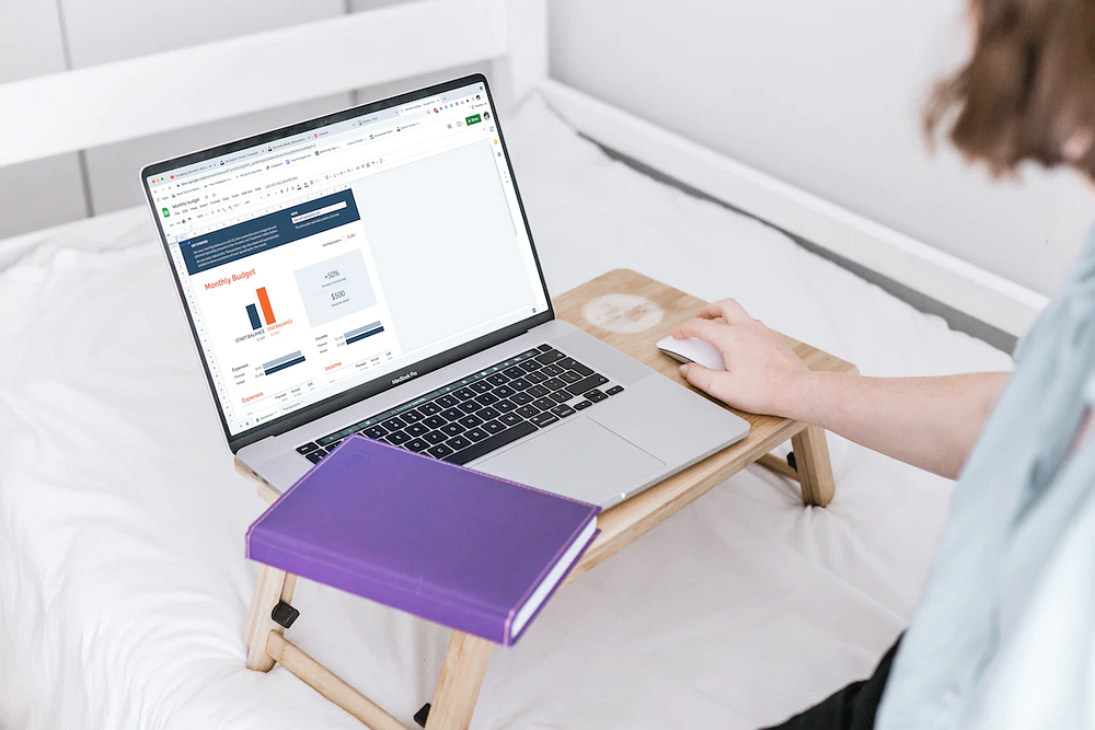 a person working on a laptop table