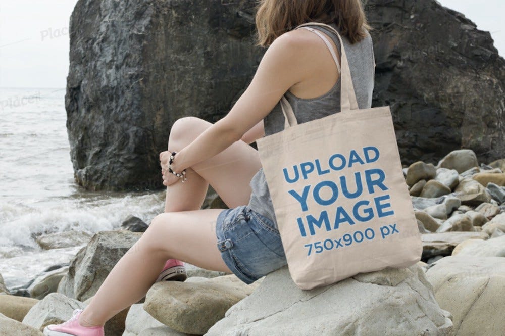 tote bag mockup featuring a young woman on the beach
