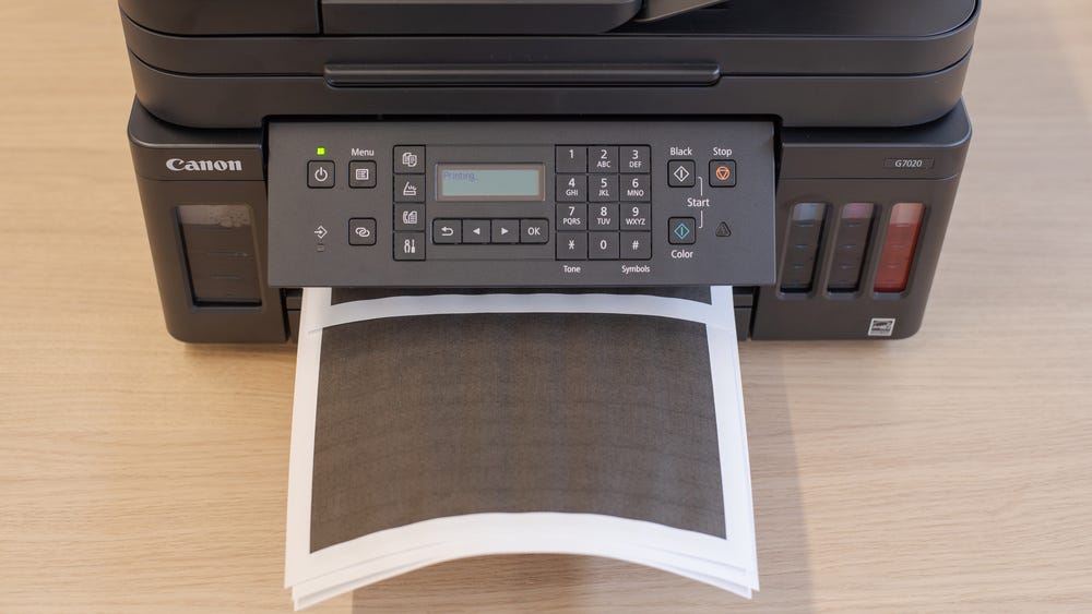 Canon Printer With A Load of Paper in Paper Tray.