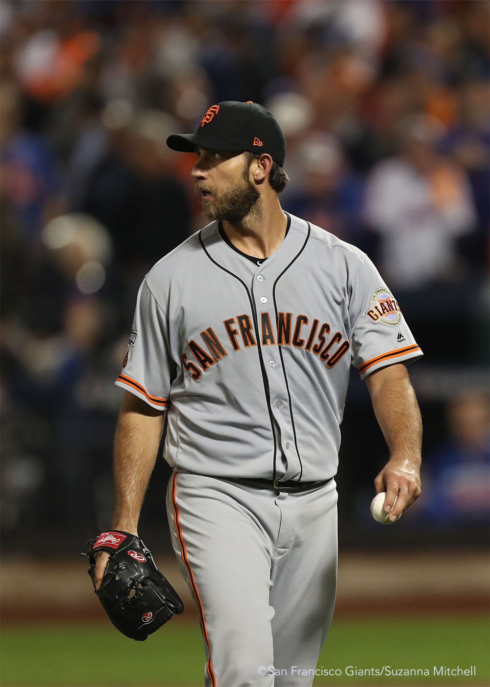 Madison Bumgarner leaves the field after catching a ball lined by Adsdrubal Cabrera to end the eighth inning.