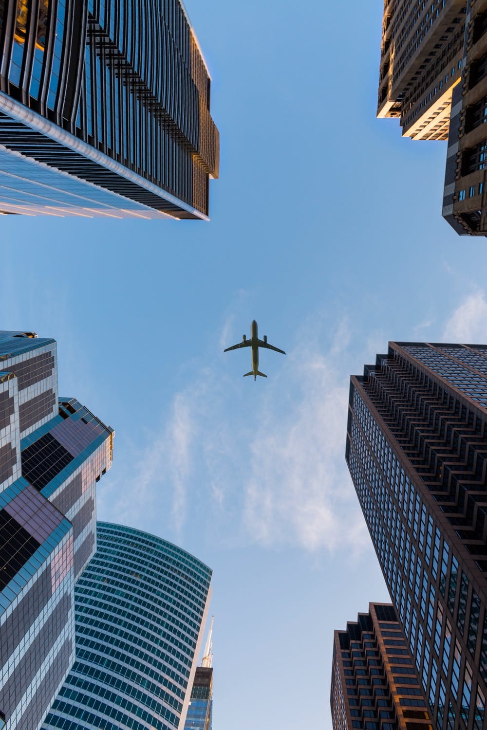 An Aeroplane flying over buildings.