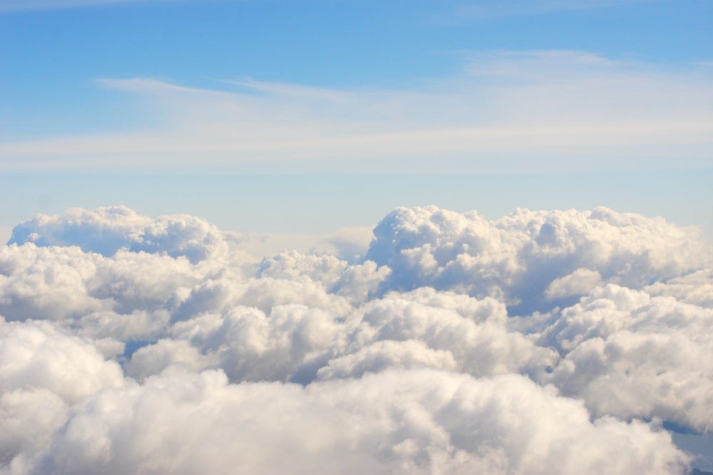 Blue sky with white rolling clouds.