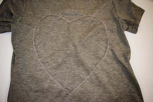 Here's another tutorial on how to make a heart cut out shirt. Do you remember this heart cut-out t-shirt refashion?  I love that shirt.  Everyone else loves that shirt, too.  I get soooo many compliments on it.  The best part about that t-shirt is that it is a 10 minute, quick sew tutorial.  Well, this year, I have another quick-sew, step-by-step DIY tutorial on how to refashion a plain gray t-shirt into a back heart cutout for Valentine's Day!