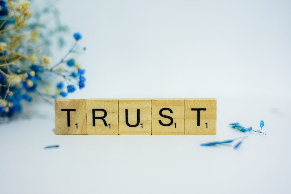Word “trust” from scrabble pieces