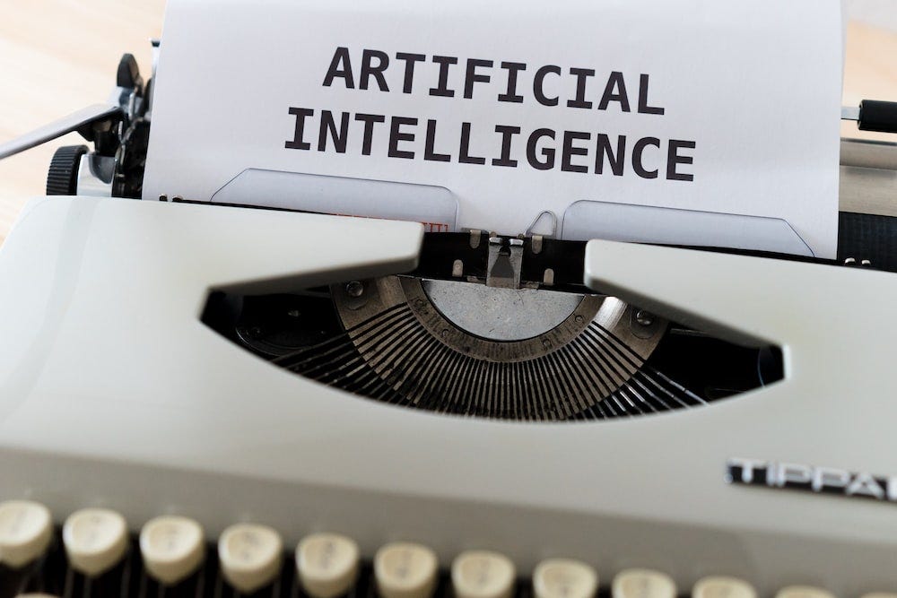 White and black typewriter with the paper that says “artificial intelligence”