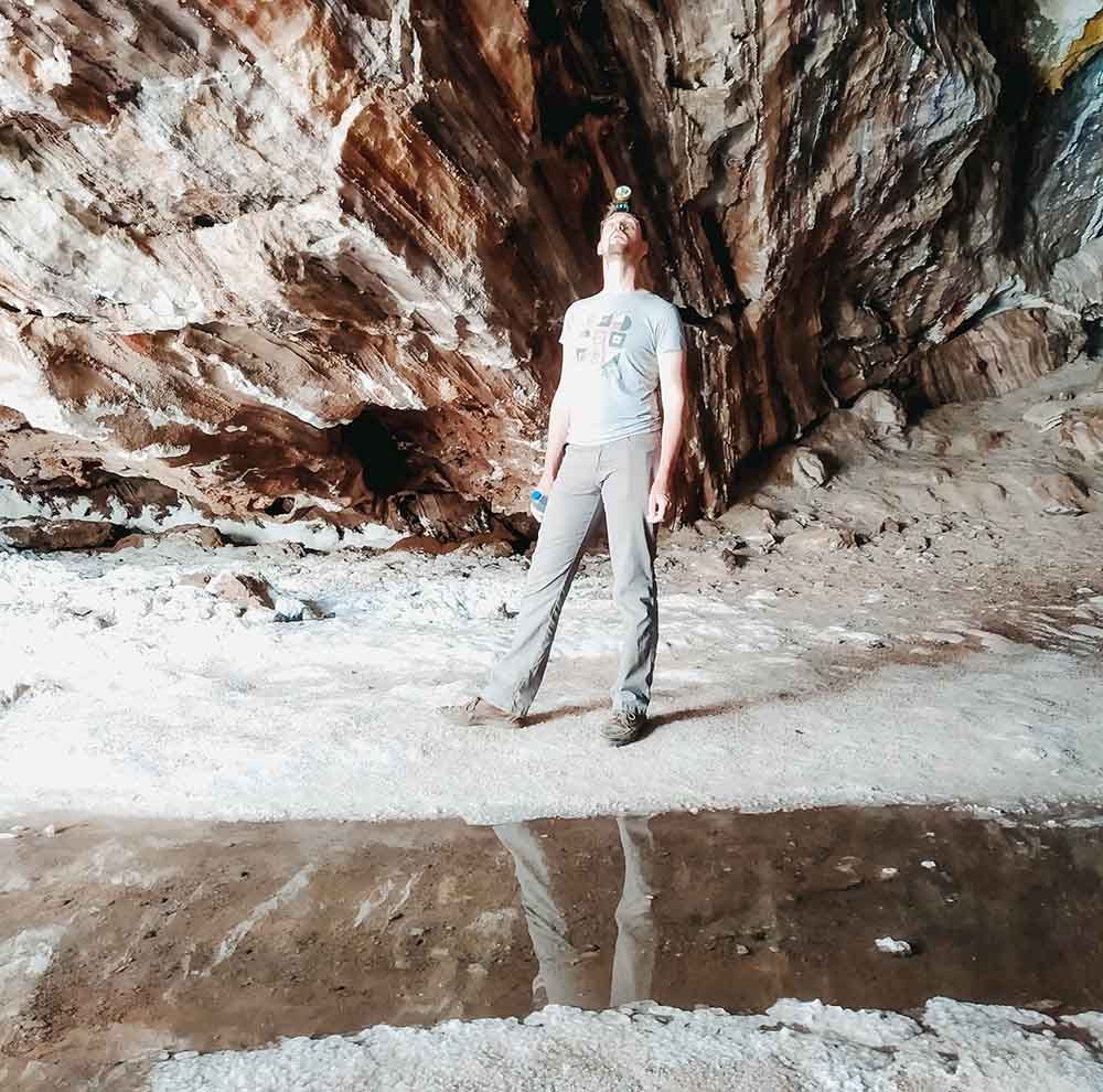 A male tourist looking up inside a salt cave at Qeshm.