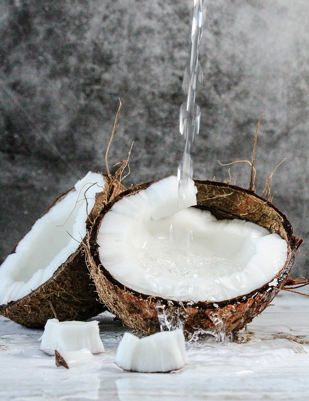 Coconut water pouring into coconut