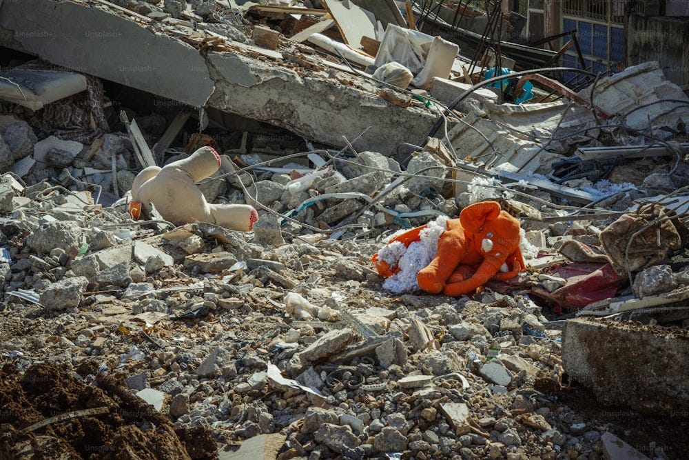 Stuffed animals lying in the rubbled of a bombed-out building