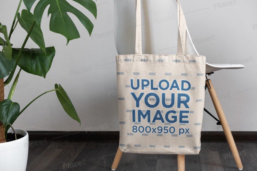 mockup of a tote bag hanging from a modern chair