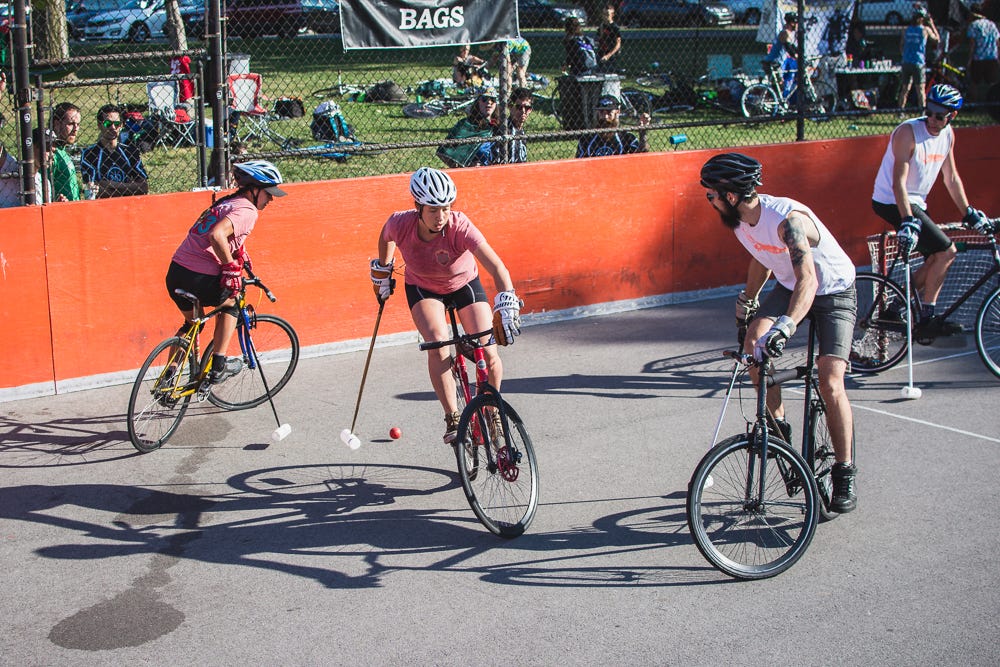 bike polo players passing the ball