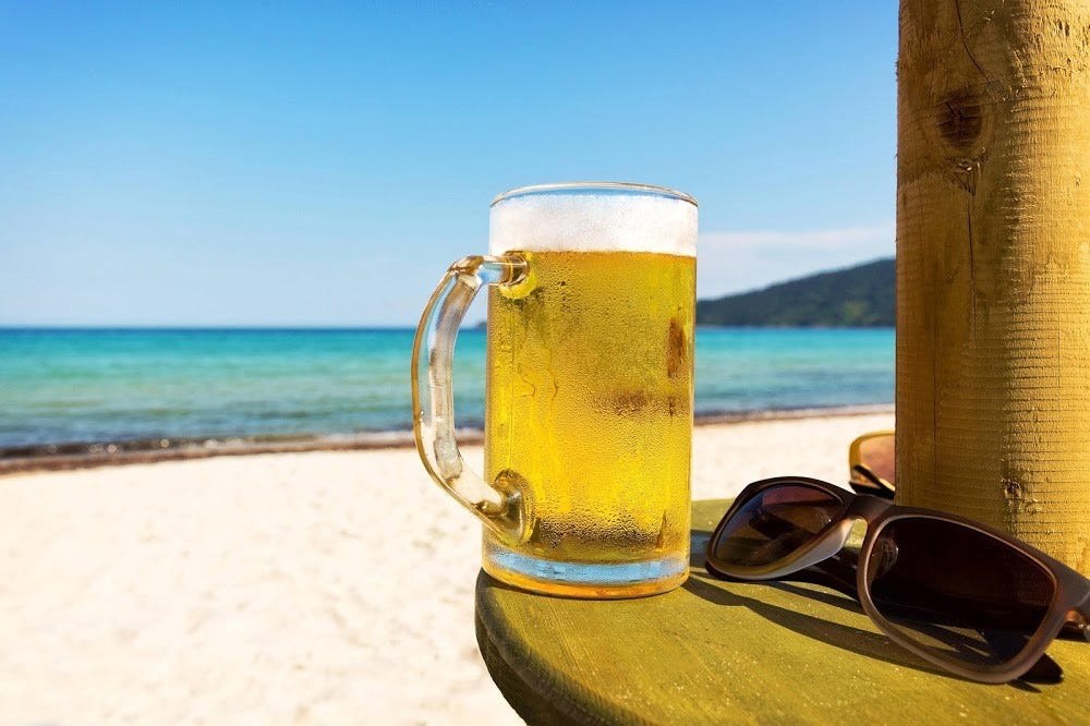 50 Best Beer Brands in India — Golden frothy beer mug on beach side