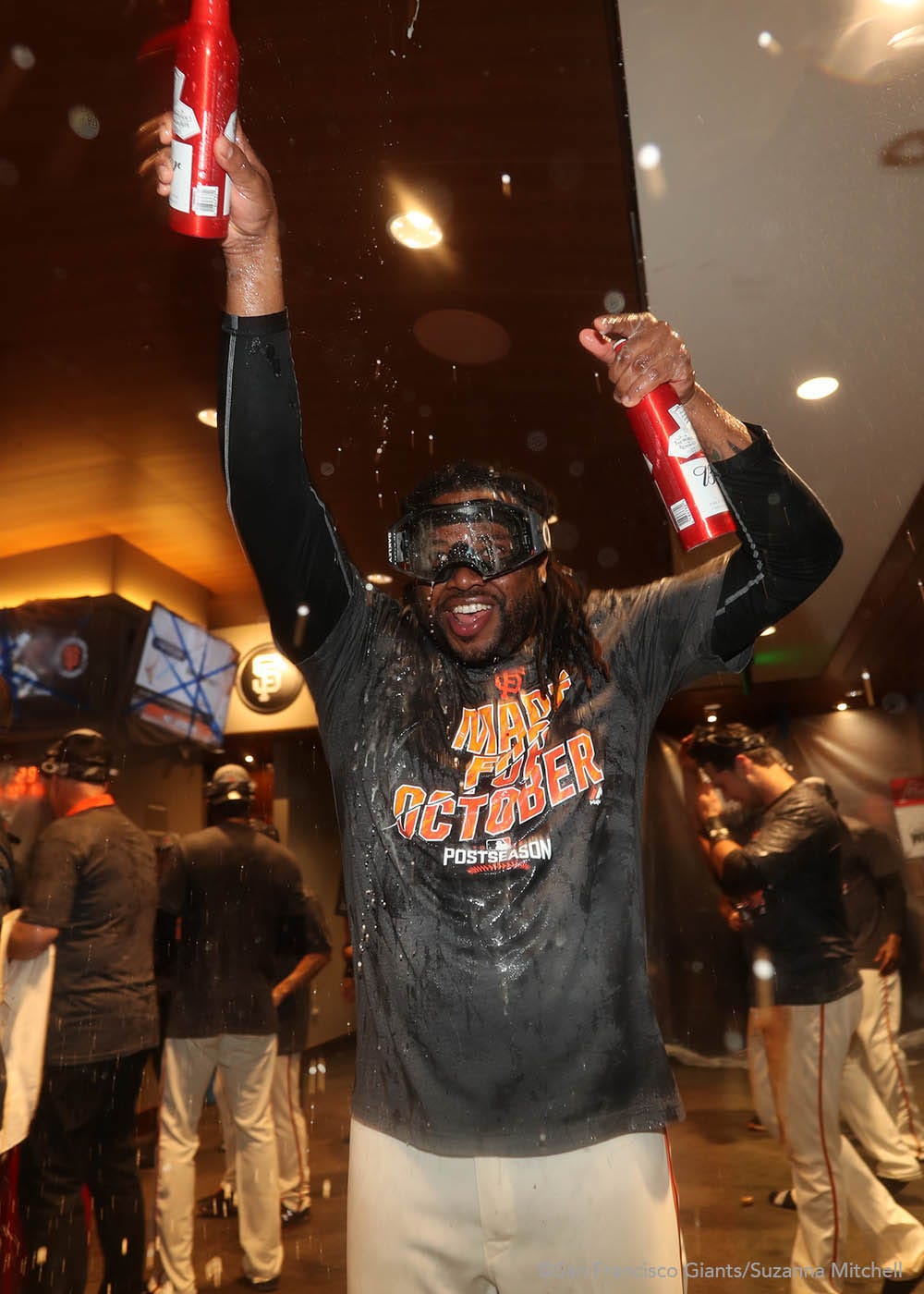 Johnny Cueto celebrates in the clubhouse.