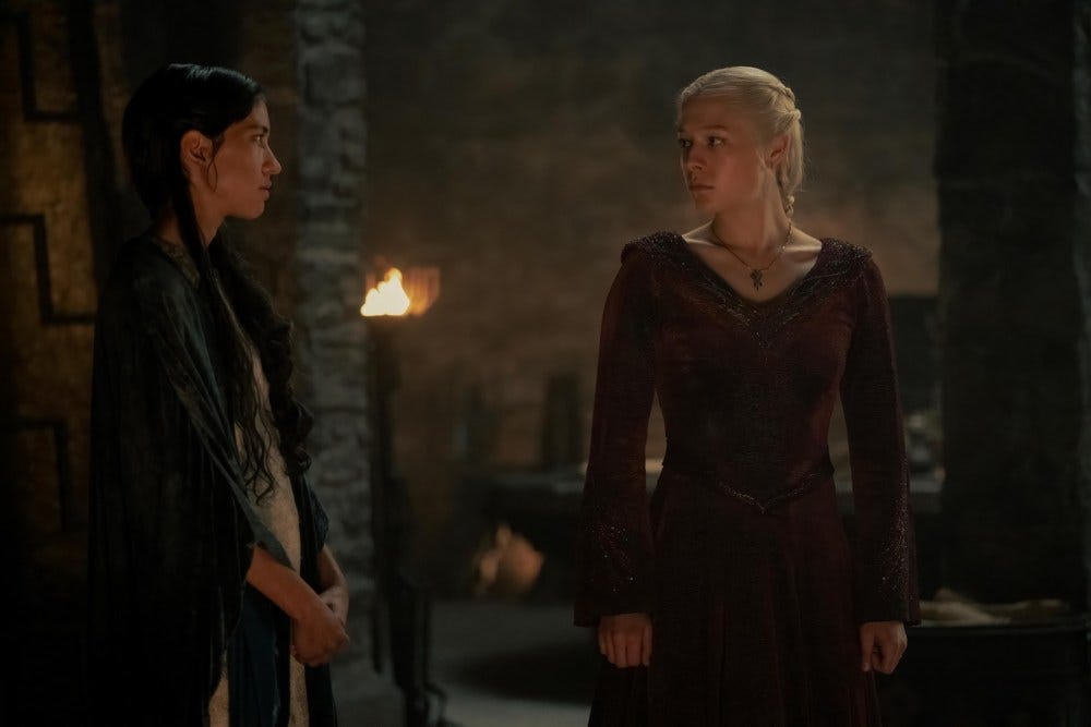 Mysaria and Rhaenyra stare at each other in a dim-lit room