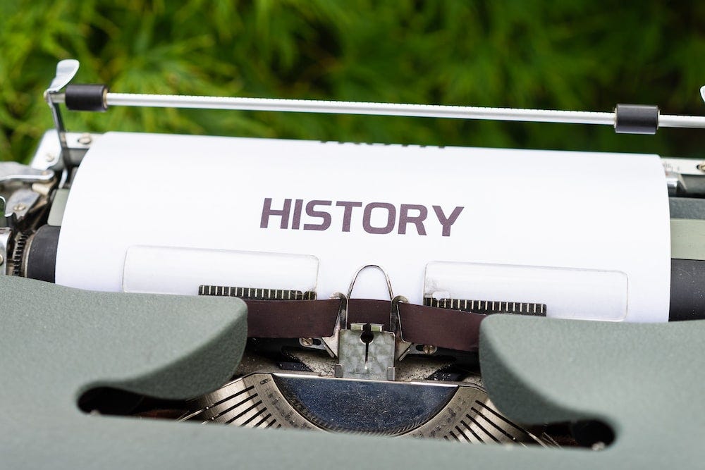 The word “History” printing out of a type writer