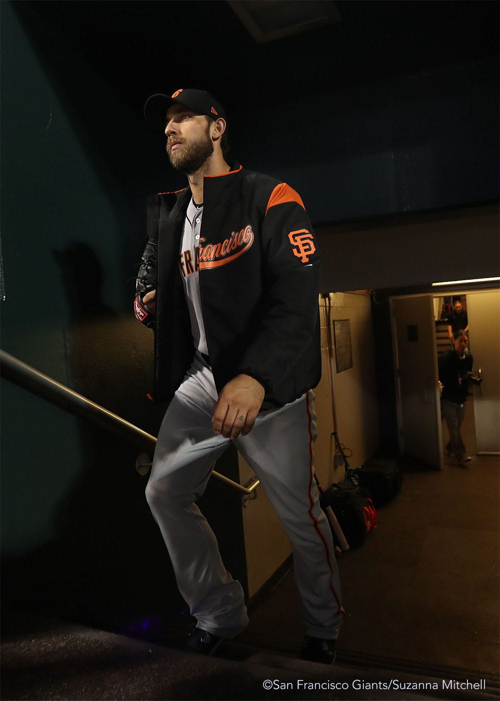 Madison Bumgarner enters the dugout to begin warming up for the game.