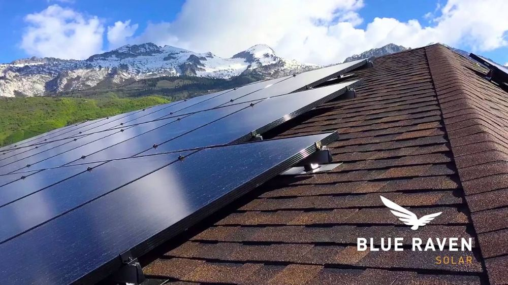 view from the roof of a house with solar panels and a placed logo of a solar company on snowy mountains