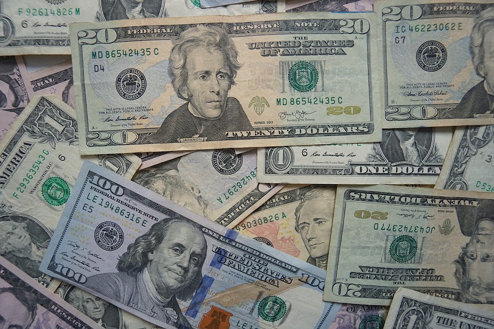 assortment of dollar bills | how payroll works