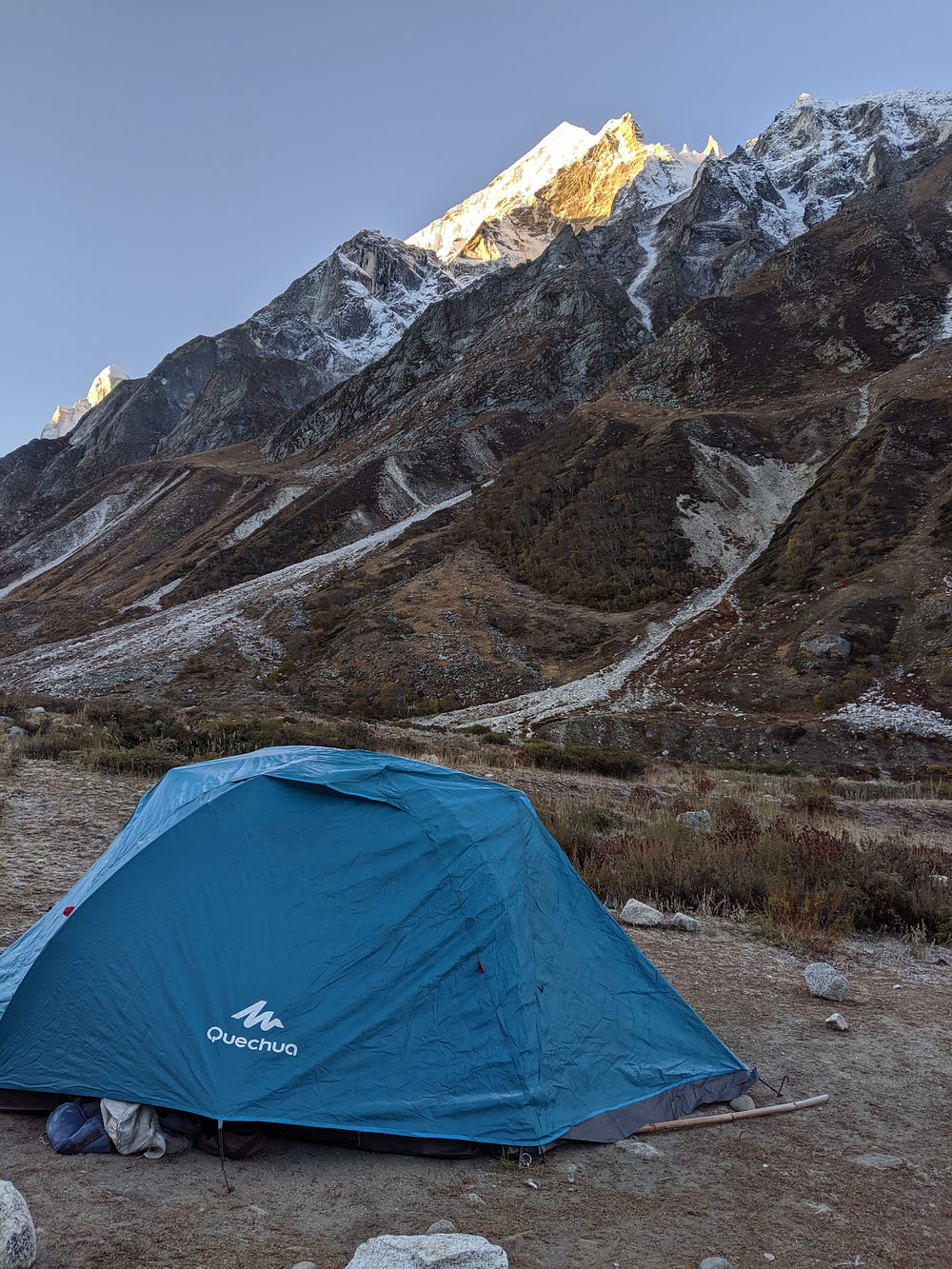 decathlon brand tent with snowy mountains in the background