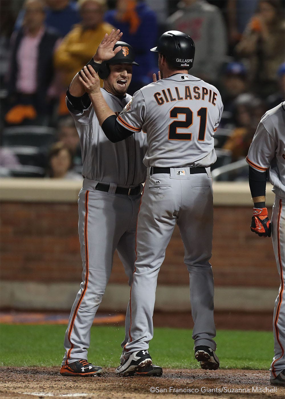 Joe Panik high fives Conor Gillaspie after scoring on the home run he hit in the ninth inning.