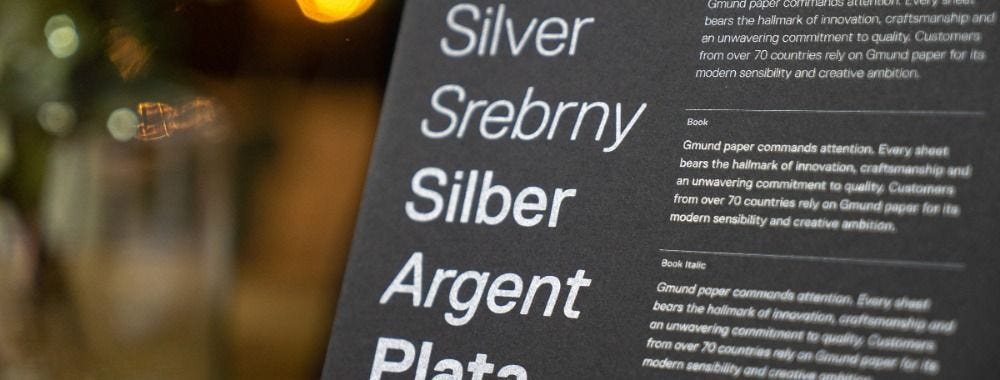 Photo of different fonts and their descriptions. The text is in white, printed on black paper.