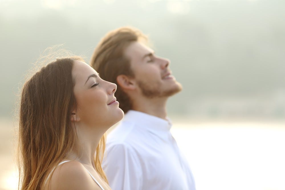 Couple enjoying a deep breath together — conveying breathwork benefits