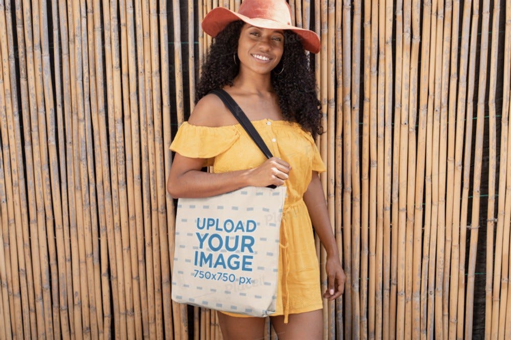 canvas bag around a woman’s shoulder promoting summer vibes