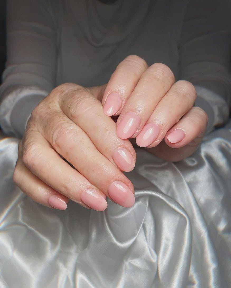 Deluxe Manicure: Close-up of hands receiving a deluxe manicure at Athira Spa in Altrincham.