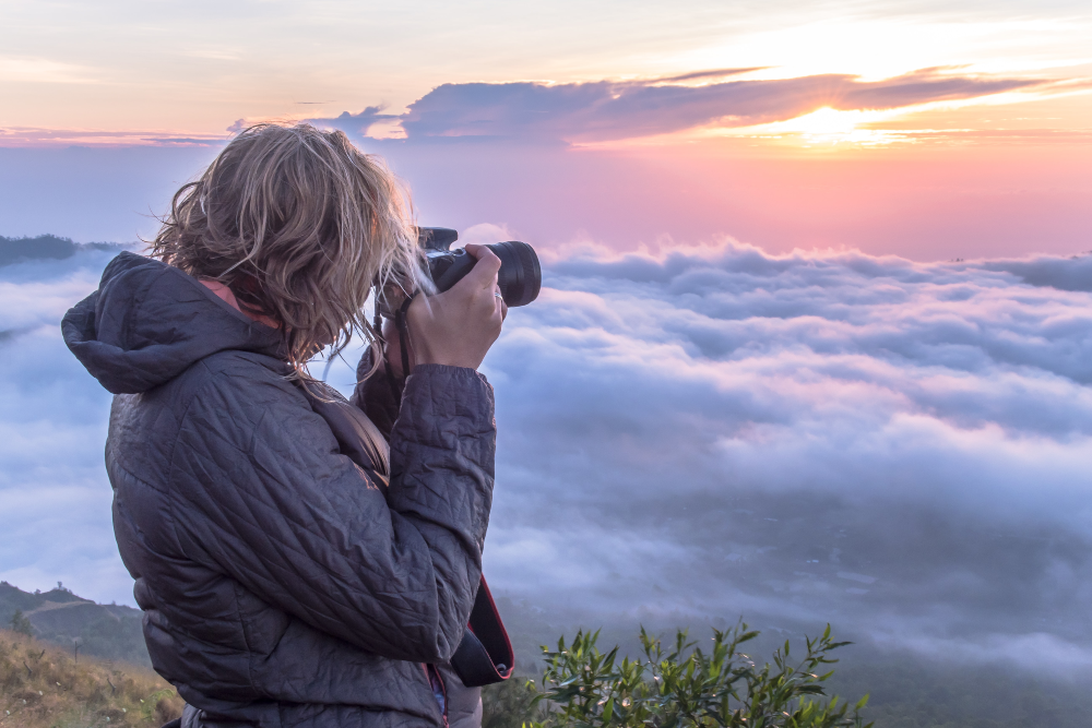 Photographer taking photos above clouds
