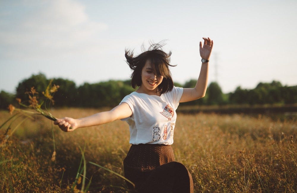 Self Expression | Girl is expressing happiness in field.