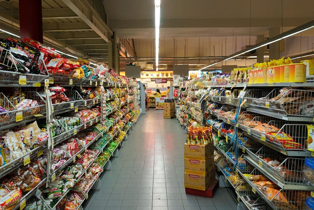 This photo captures 2 aisles of a grocery store.