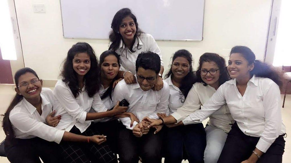 A boy has been forced to click photo by sitting with bunch of girls