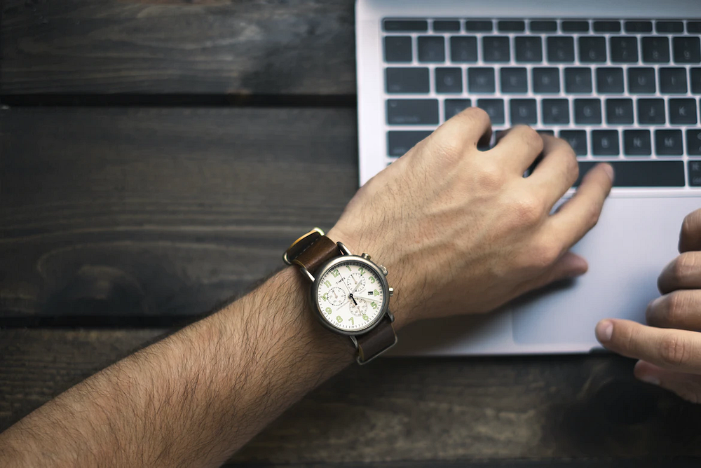 a leather wristwatch worn on the left wrist