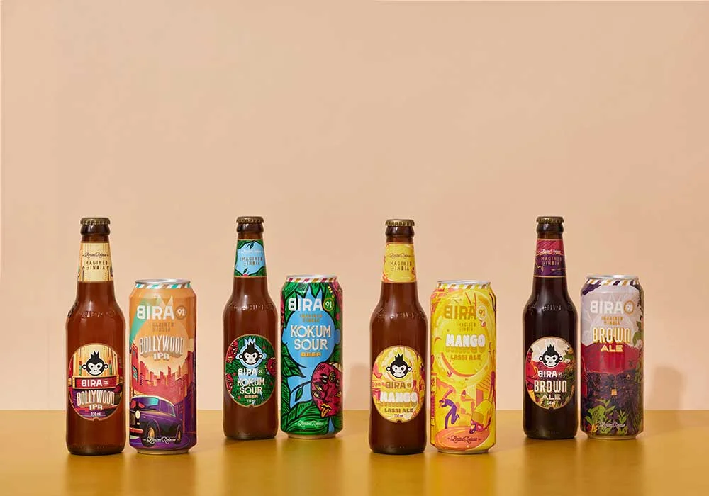 Beer bottles and cans with different design on table