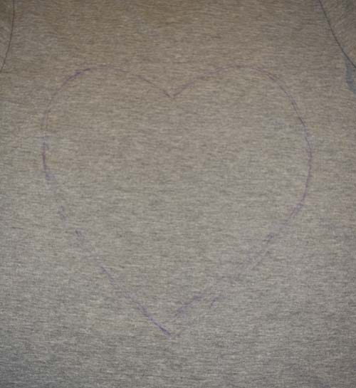 Here's another tutorial on how to make a heart cut out shirt. Do you remember this heart cut-out t-shirt refashion?  I love that shirt.  Everyone else loves that shirt, too.  I get soooo many compliments on it.  The best part about that t-shirt is that it is a 10 minute, quick sew tutorial.  Well, this year, I have another quick-sew, step-by-step DIY tutorial on how to refashion a plain gray t-shirt into a back heart cutout for Valentine's Day!