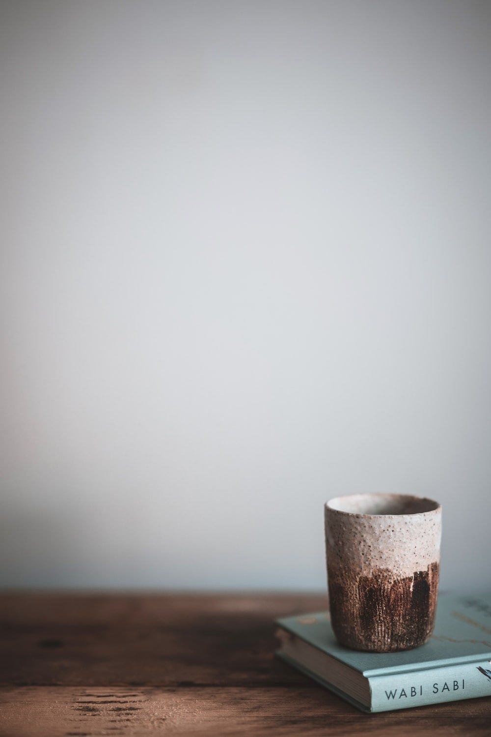 Wabi sabi mug sitting on top of a book about wabi sabi