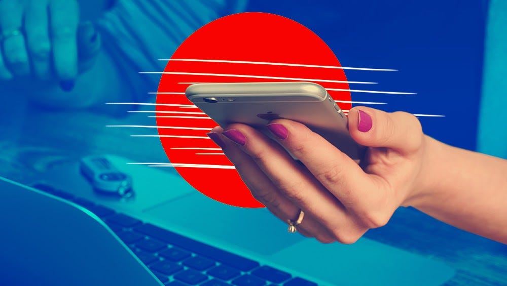 woman’s hand holding silver iphone in front of red circle, above an opened laptop in blue background