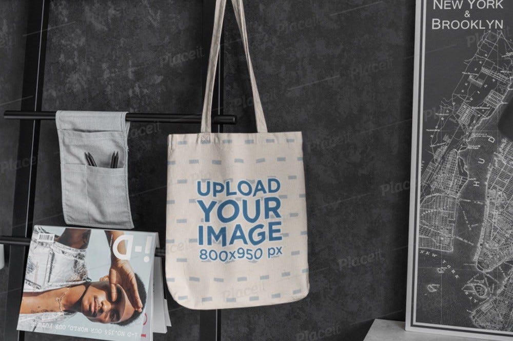 a 100% editable canvas bag hanging from a metal rack