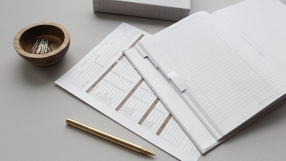 finance tracker sheets on a table