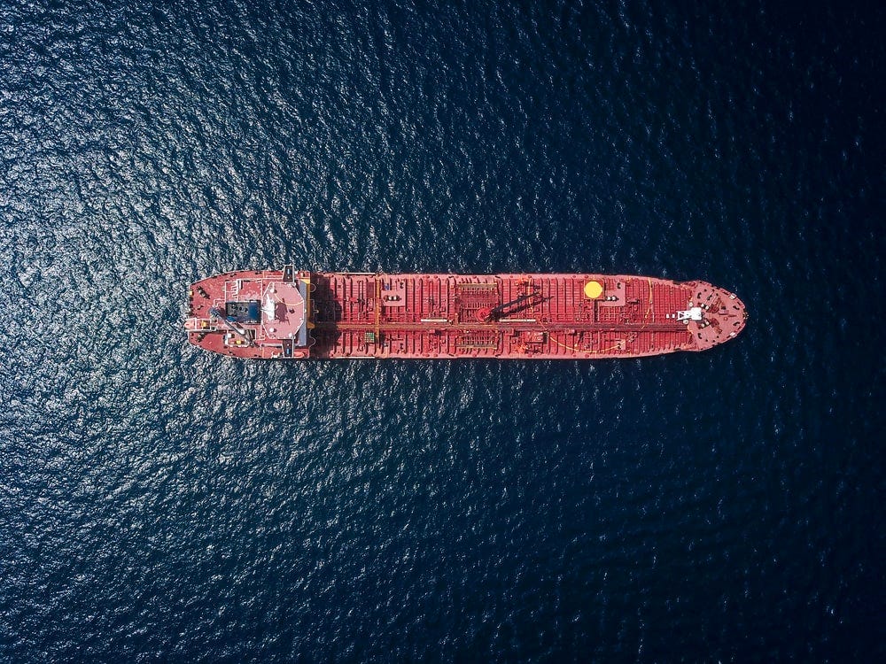 A ship in the sea with a bunch of goods on it.