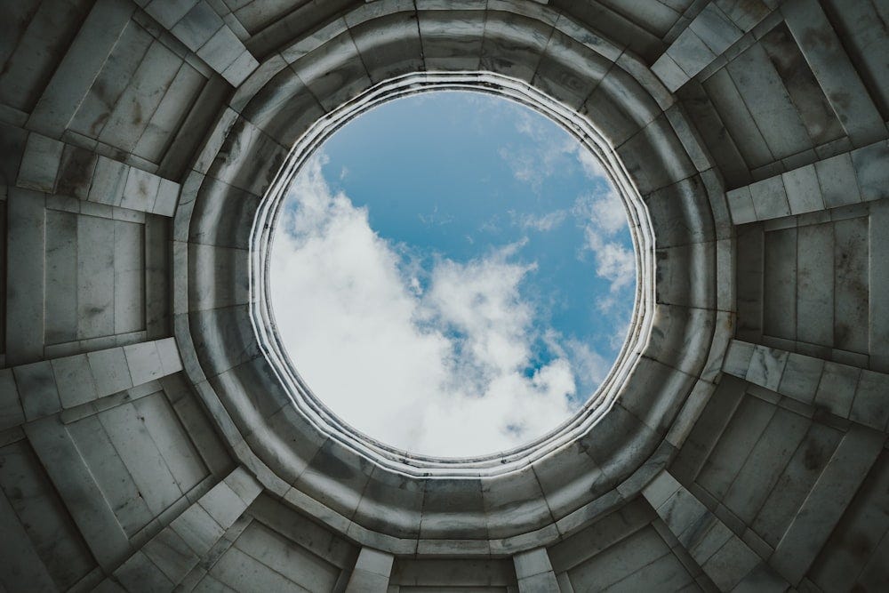 A glimpse into the sky, framed perfectly in the center by a hole.