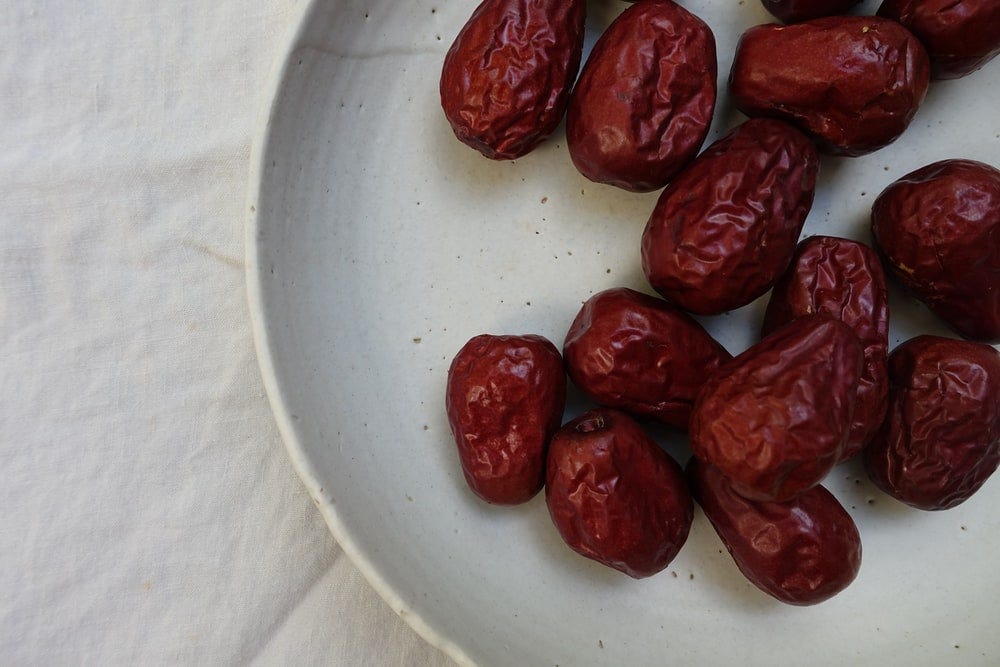 10–12 dates clustered on a plate.