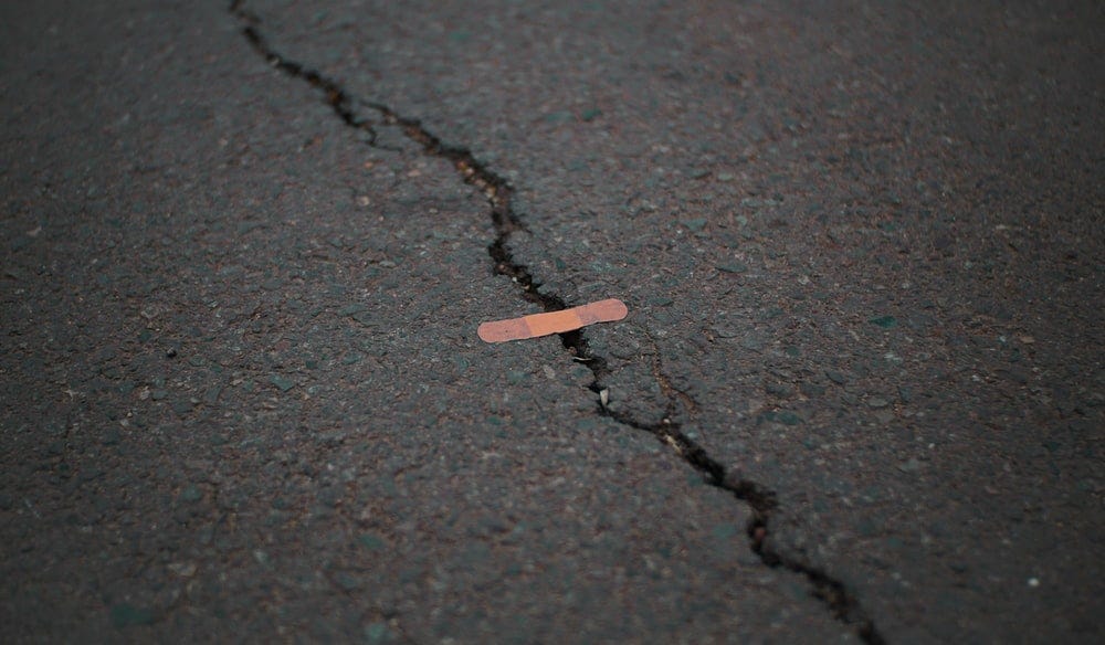 A small band-aid to stuck on top to fix the cracks in the road.