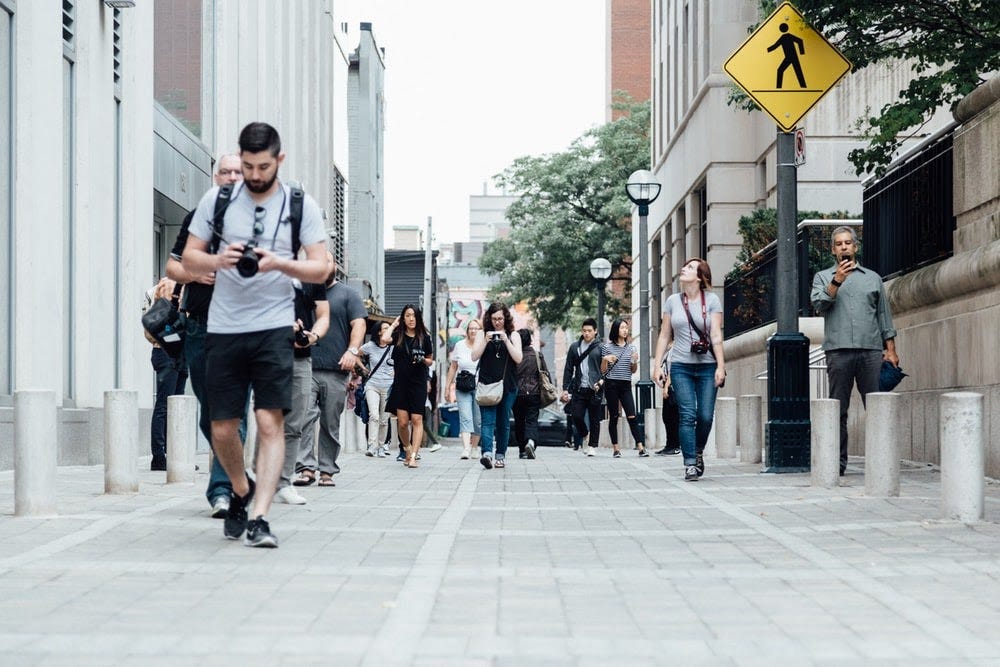 Lot of people walk through pedestrian area of the city