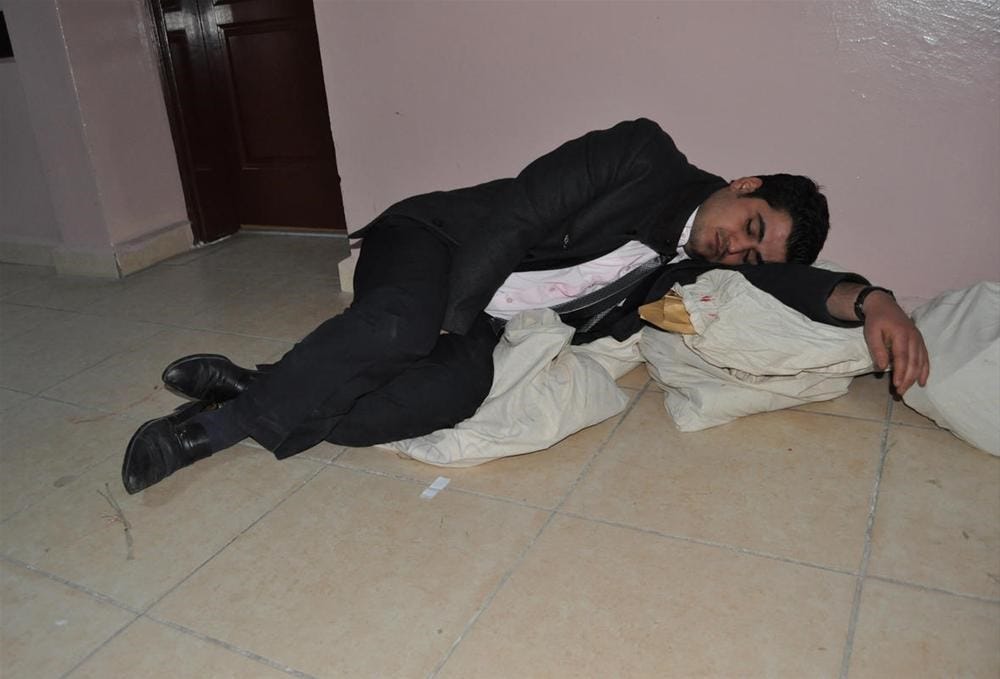 An election official sleeping over the sealed vote bags