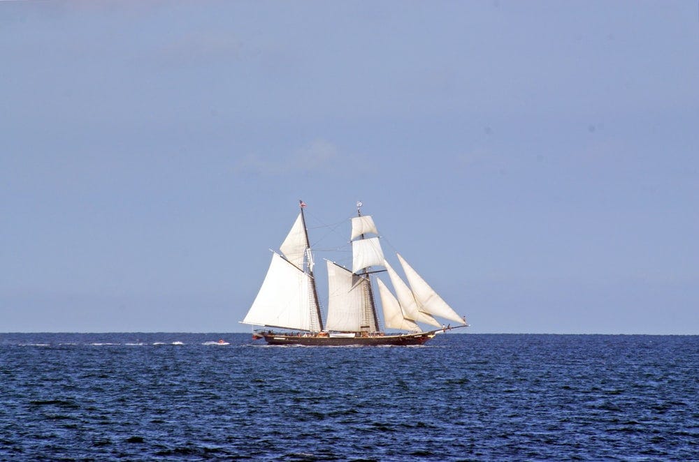 A renaissance era sailboat sailing majestically on the blue ocean