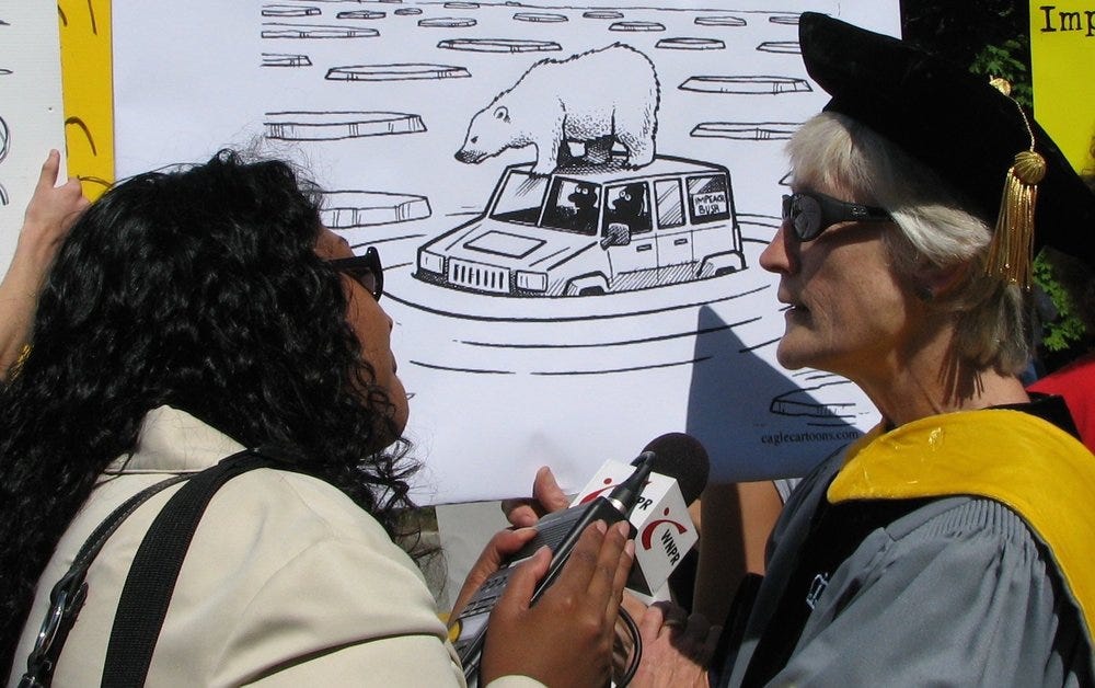 A WNPR (National Public Radio) reporter interviews a scientist protesting at the corner of Mohegan Ave. and Williams St. in New London, Connecticut. Image by Sage Ross, USA, 2007. 