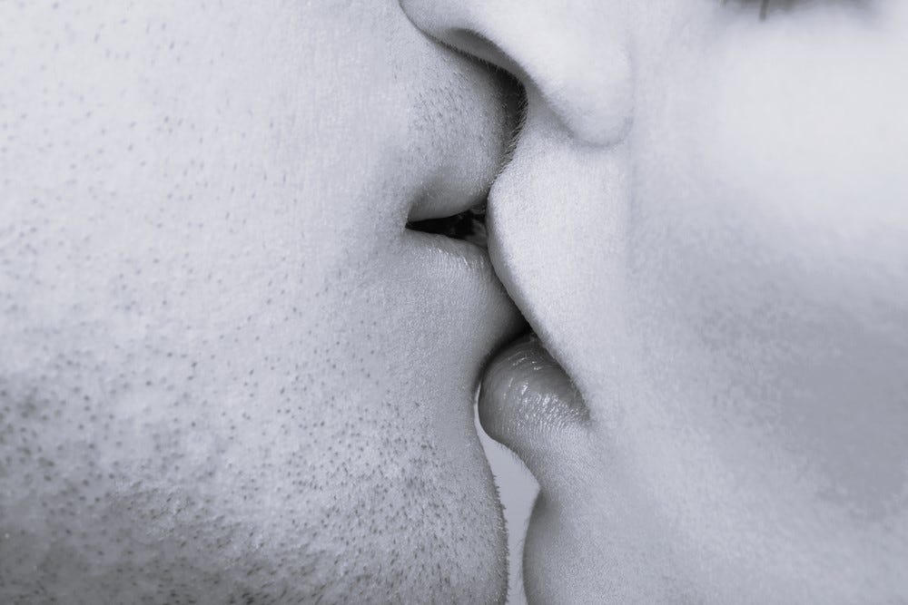 young Caucasian couple kissing in close-up